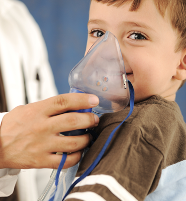 little boy with oxygen mask